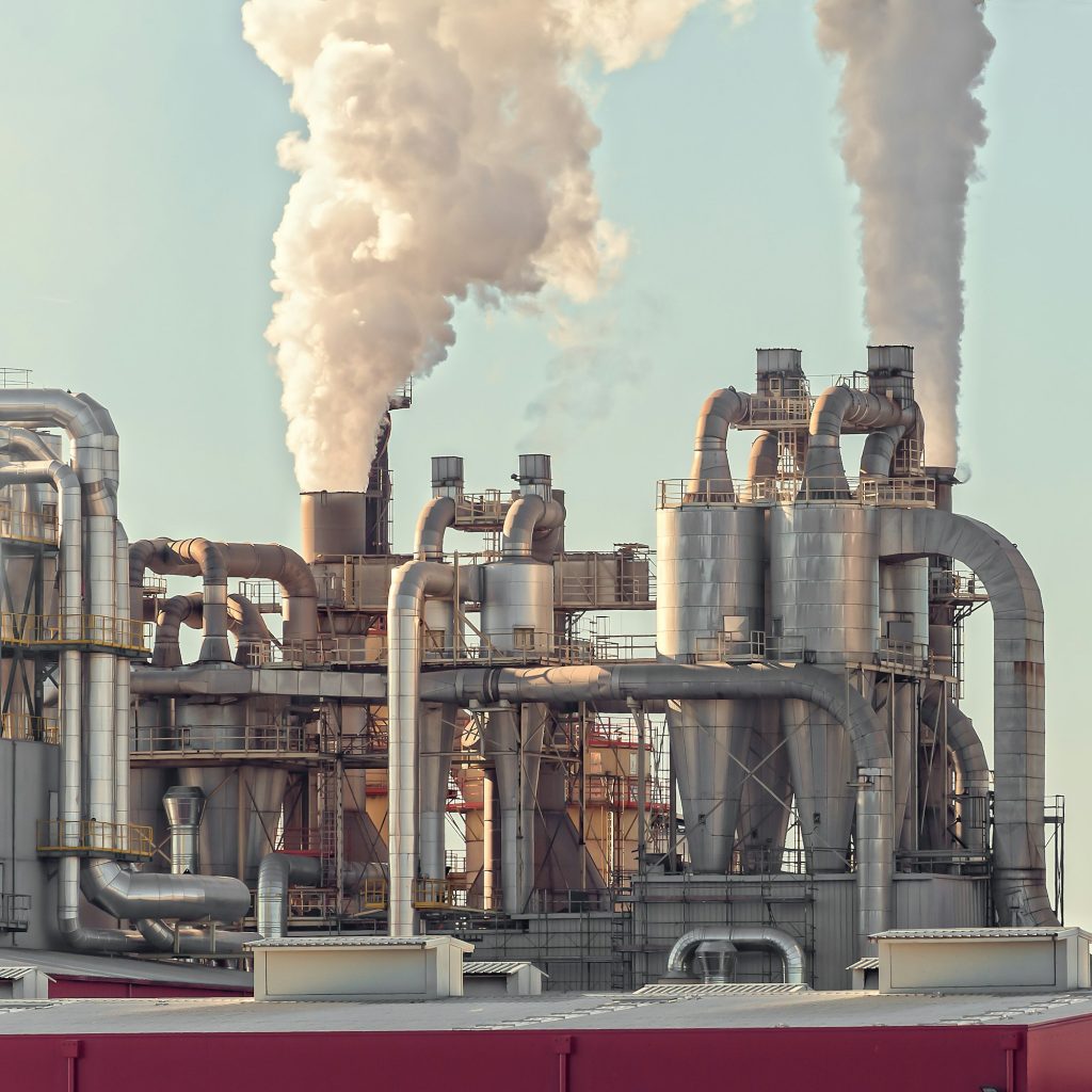 Chimney and storage tank. Chemical plant.Factory